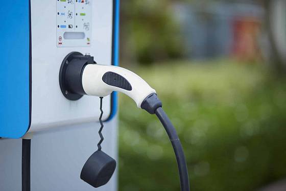 Electric car charging plug in power station