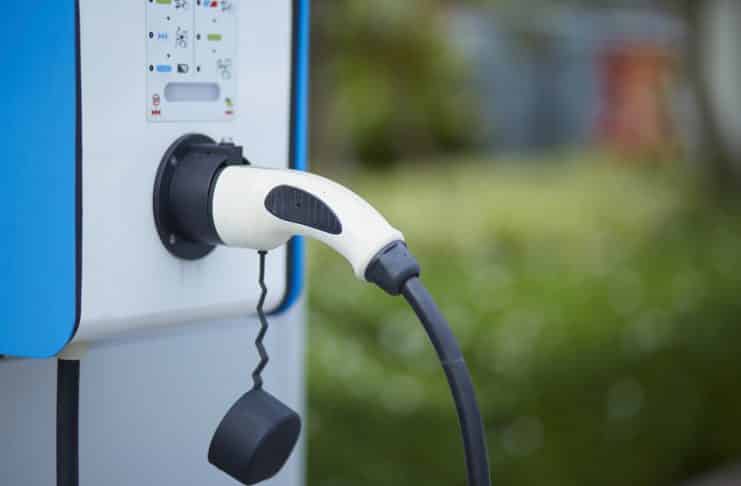 Electric car charging plug in power station